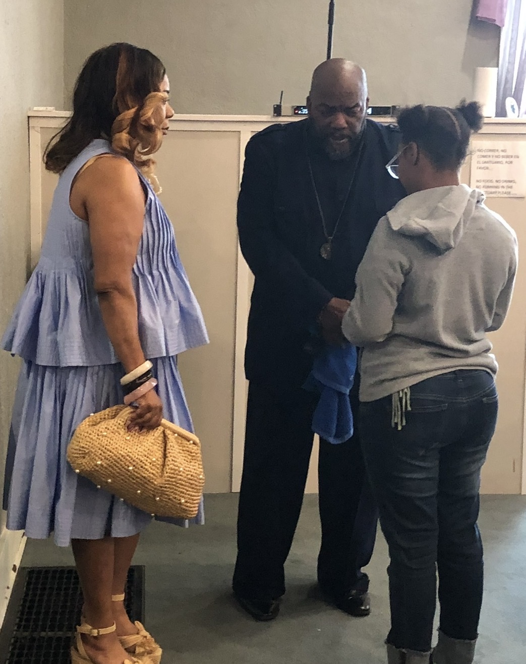 Pastor Jamison praying with members after service