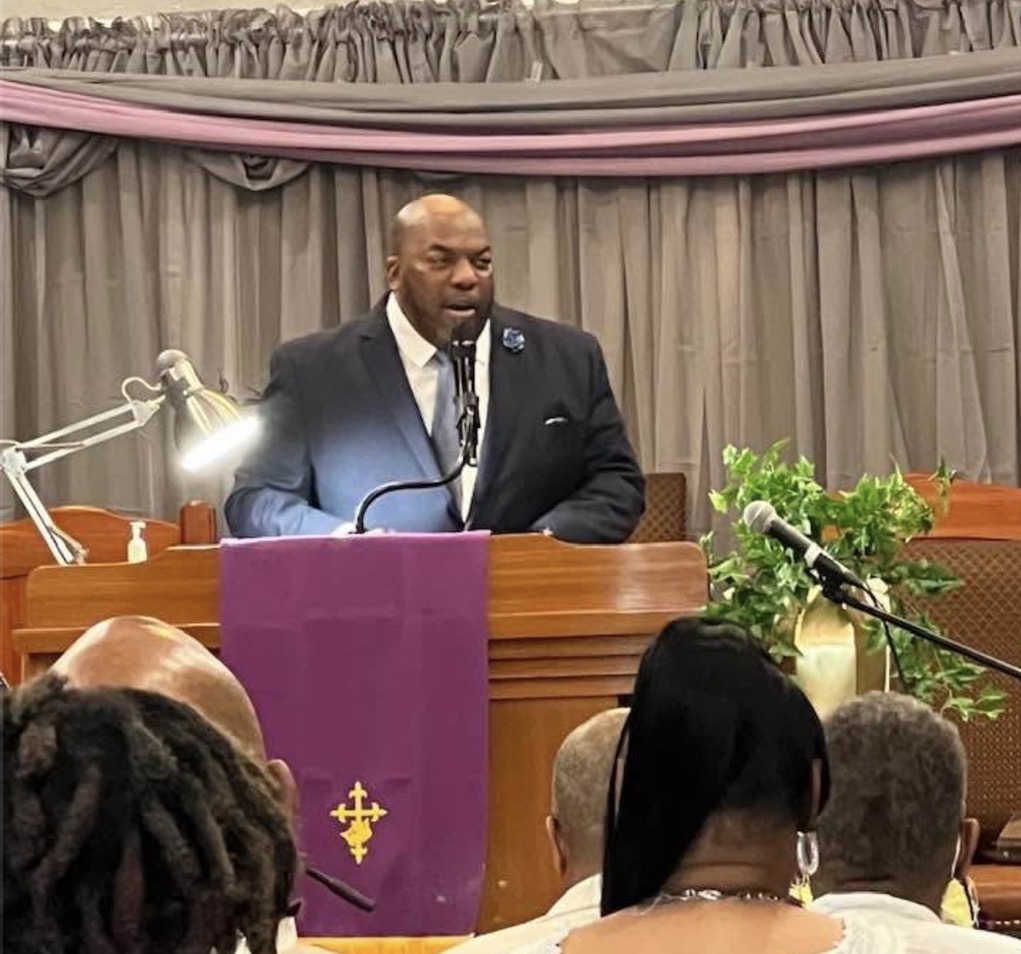 Pastor Anthony L. Jamison Sr. preaching from the pulpit at Community Church of KC
